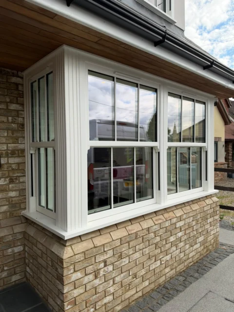 A closer view of the bay shows the white frames and Georgian-style glazing bars.