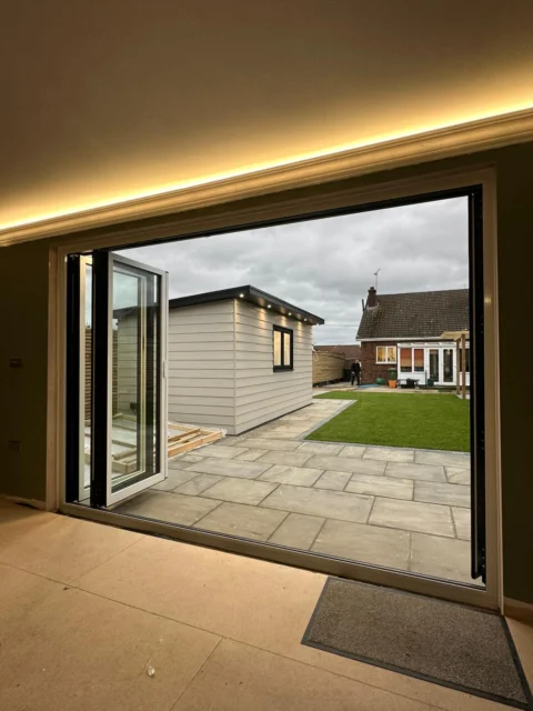Interior view with the bi-fold leaves folded back and the patio opening clear.