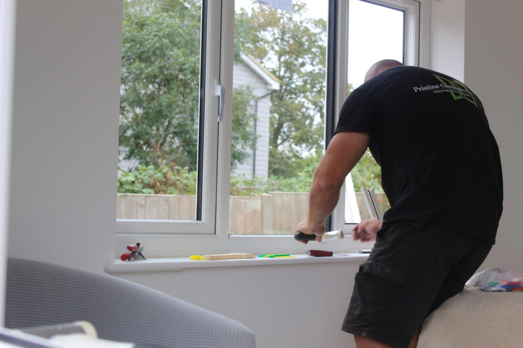 Home Pristine installer working on the inside of a white window