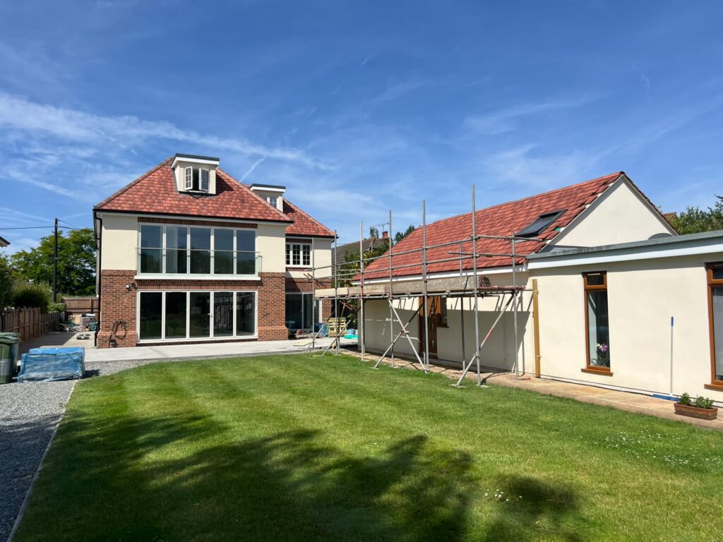 Home Rear of a house with large windows and glazed garden doors